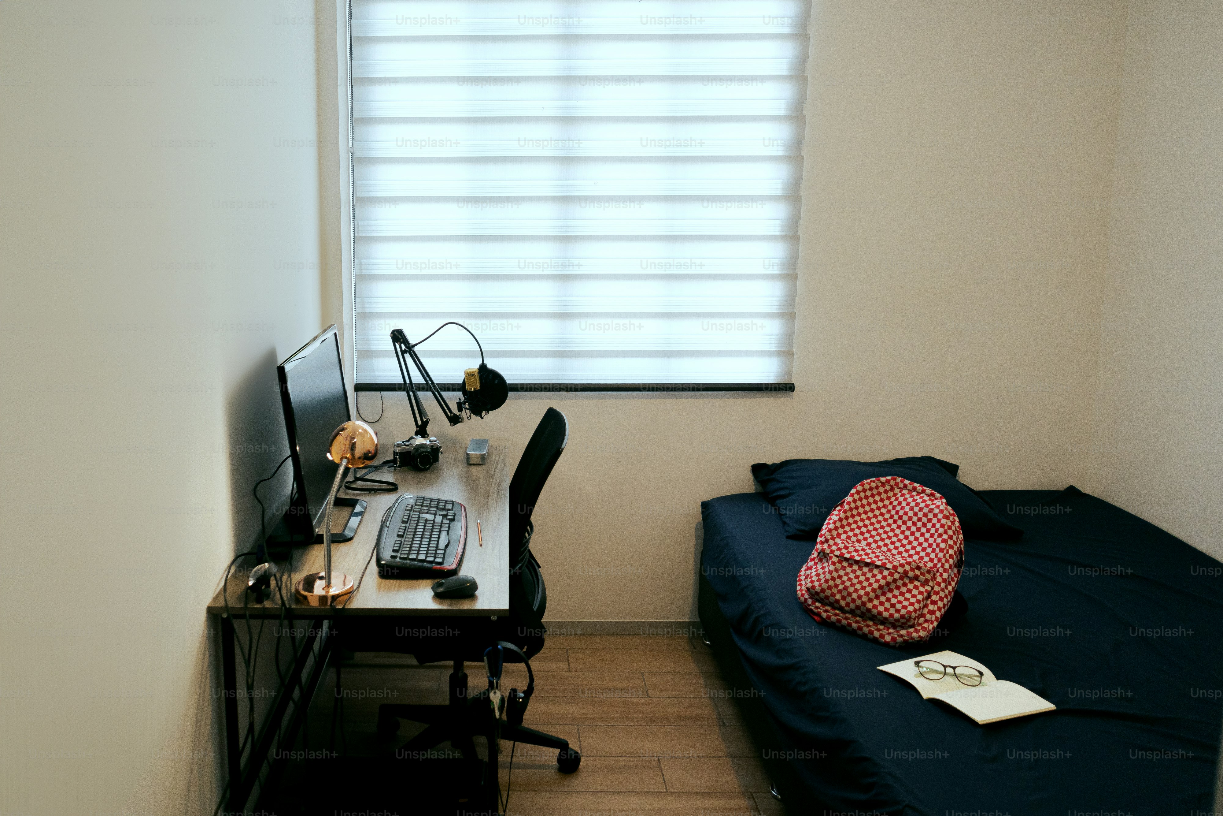 A small room with a bed and a desk